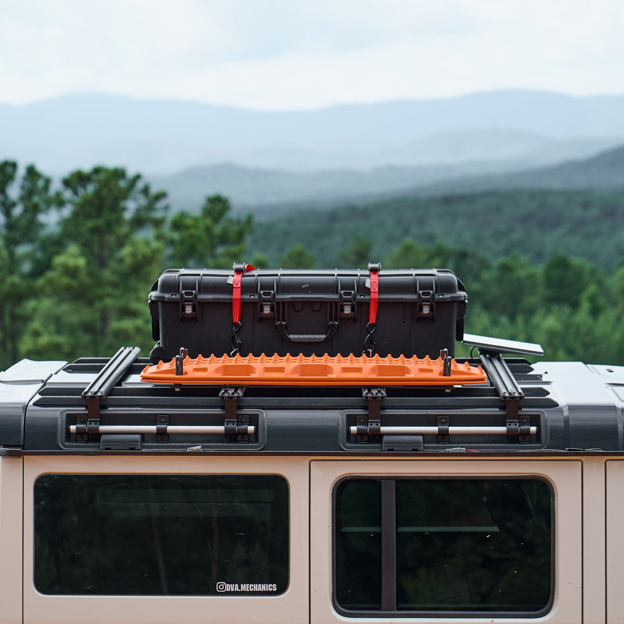 INEOS Grenadier DualTrack-T MAX roof system loaded with case and recovery board for overland trail use