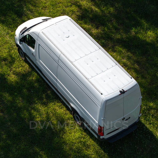 Overhead aerial view of a white Mercedes Sprinter van on grass showing the full length of the roof