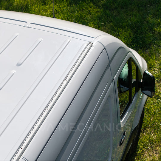 Aerial close-up of a LoadSpan roof rail installed along the front roof edge of a white Mercedes Sprinter