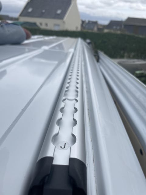LoadSpan-T dual-channel L-Track + T-Bolt — top-down install view on Sprinter roof